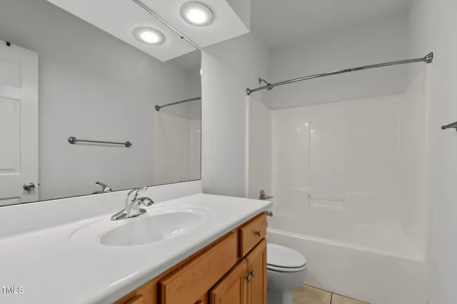 a bathroom with a sink toilet vanity and shower