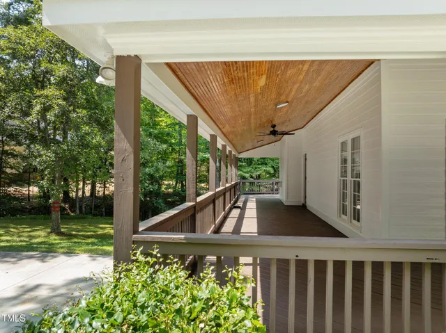 a view of a balcony with chair and wooden floor
