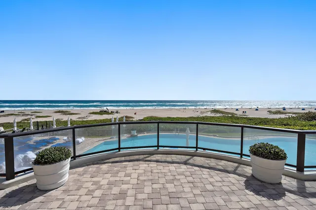 a large kitchen with a sink and stainless steel appliances