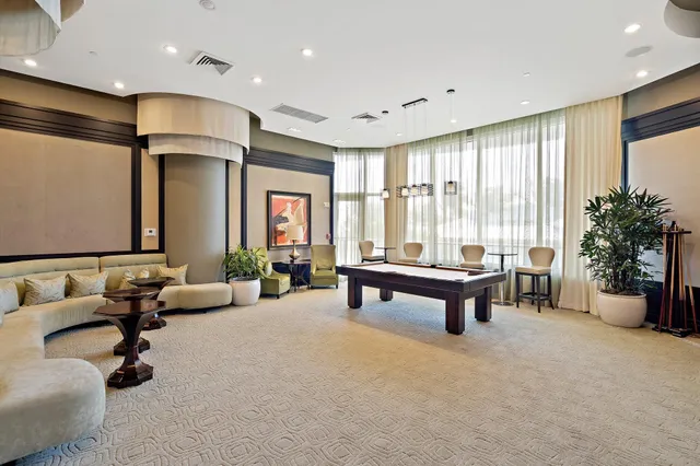 a living room with furniture a rug and a large window