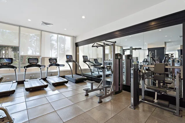 a dining room with furniture and a floor to ceiling window