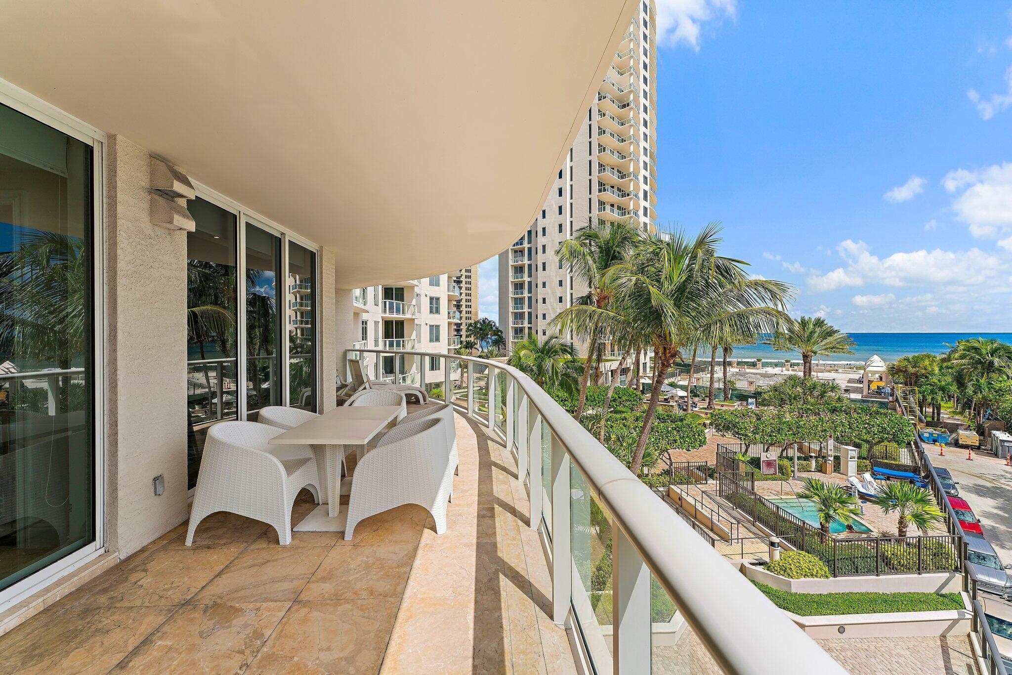2700 North Ocean Drive, Unit 304B Singer Island, FL 33404 - Photo 47 of 91 a balcony view with a large window and outdoor seating