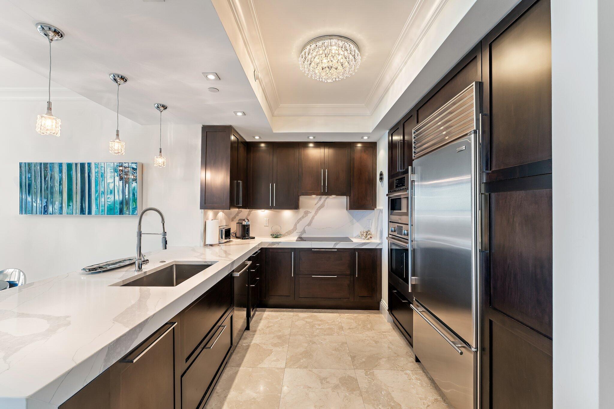 2700 North Ocean Drive, Unit 304B Singer Island, FL 33404 - Photo 55 of 91 a large kitchen with a sink and stainless steel appliances