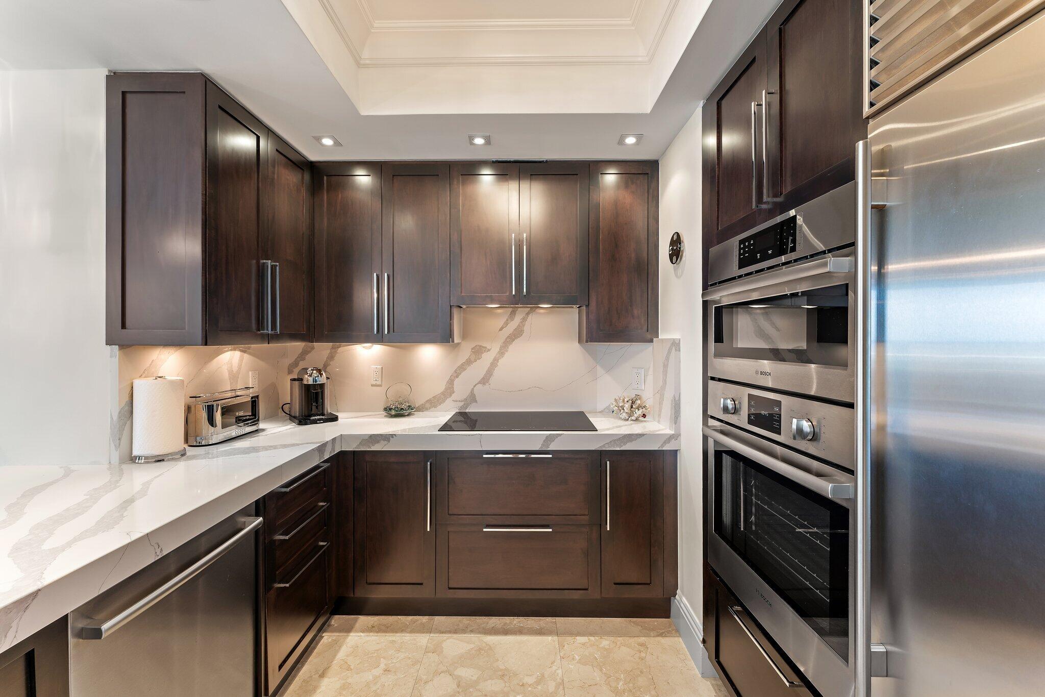 2700 North Ocean Drive, Unit 304B Singer Island, FL 33404 - Photo 57 of 91 a kitchen with a sink and stainless steel appliances