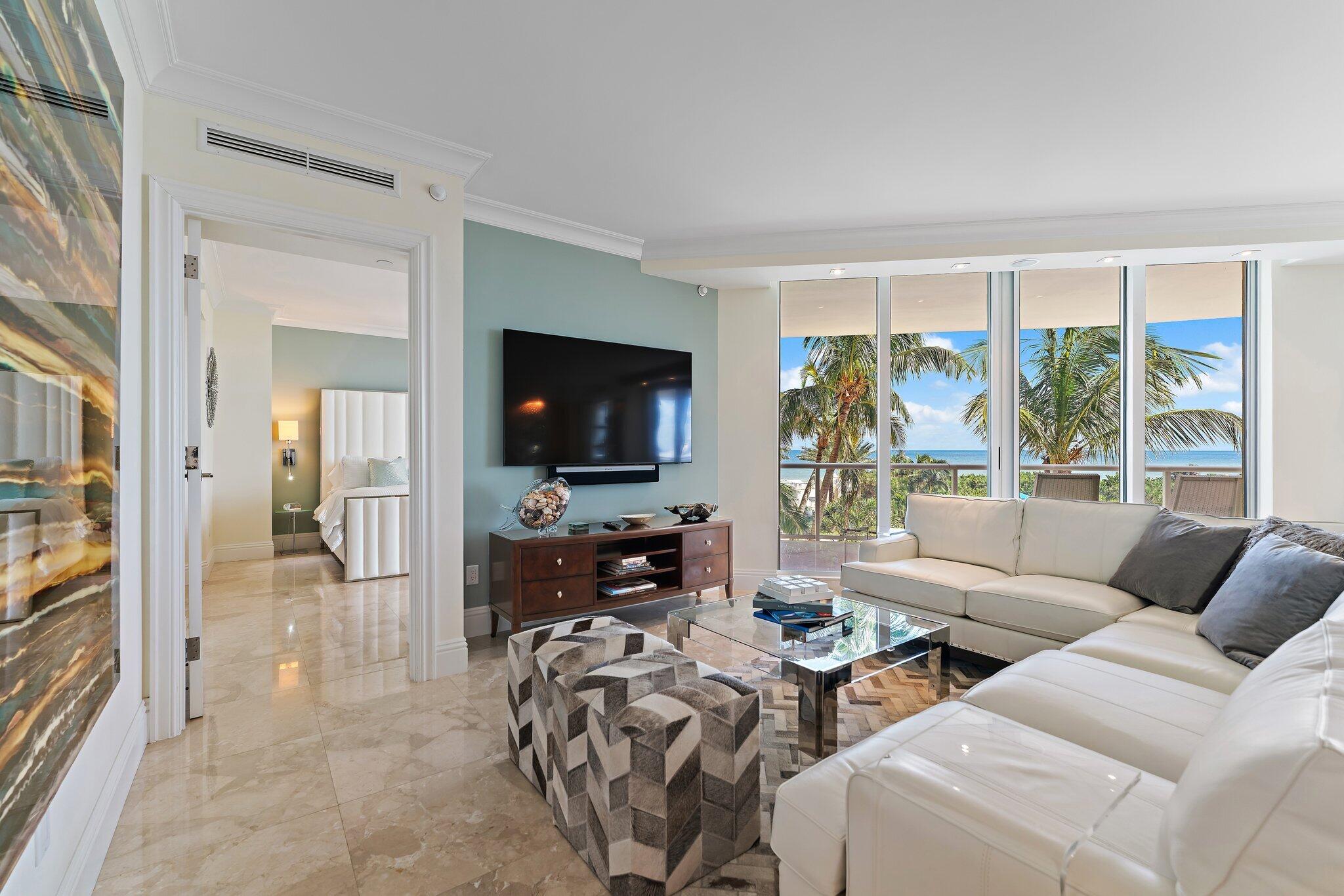 2700 North Ocean Drive, Unit 304B Singer Island, FL 33404 - Photo 60 of 91 a living room with furniture and a flat screen tv
