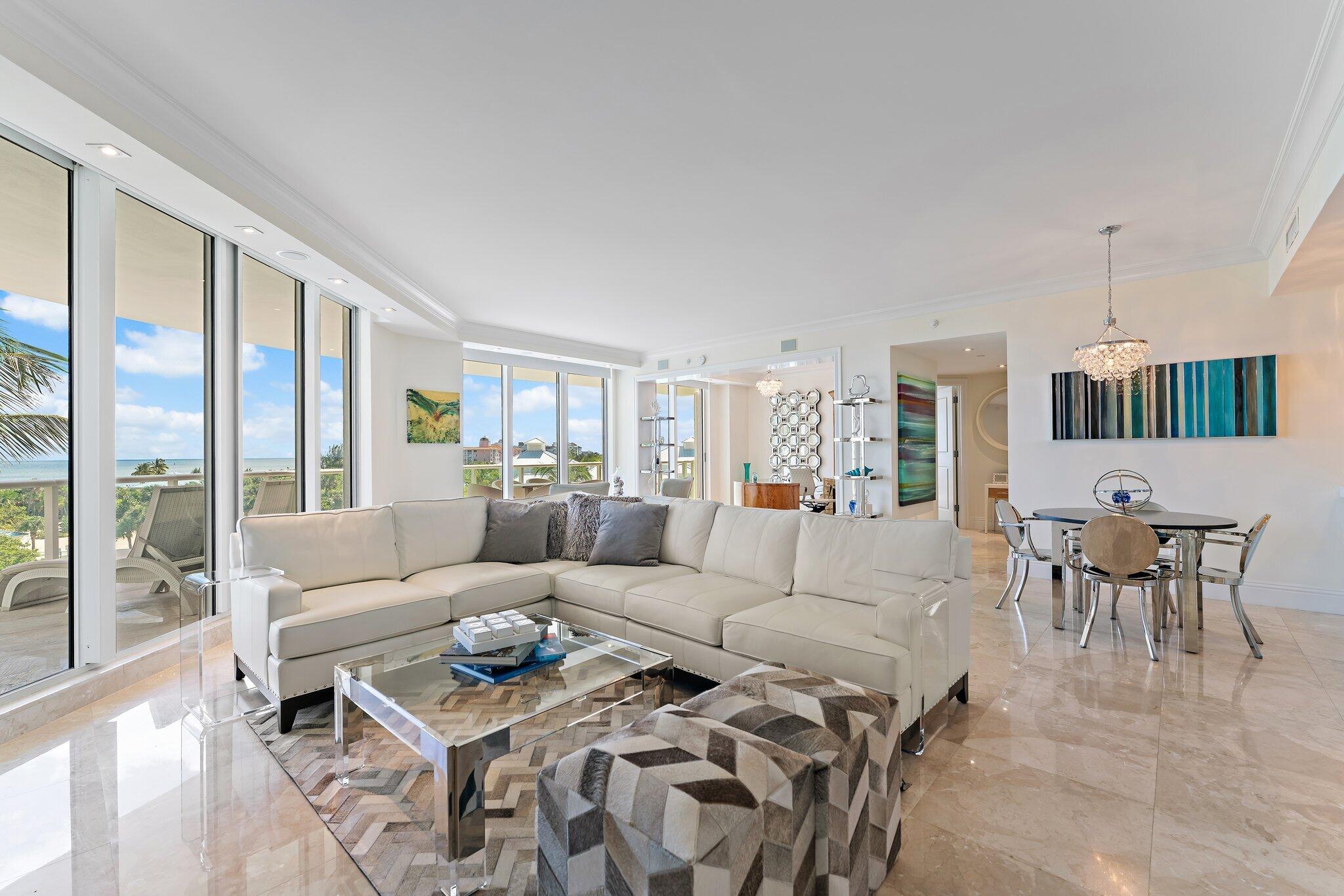 2700 North Ocean Drive, Unit 304B Singer Island, FL 33404 - Photo 61 of 91 a living room with furniture a large window and a table