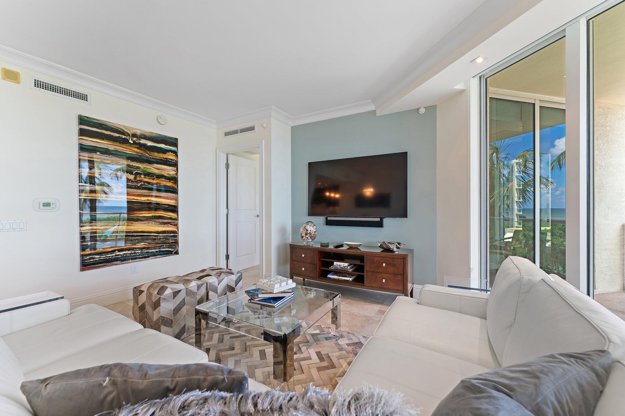 2700 North Ocean Drive, Unit 304B Singer Island, FL 33404 - Photo 62 of 91 a living room with furniture and a flat screen tv
