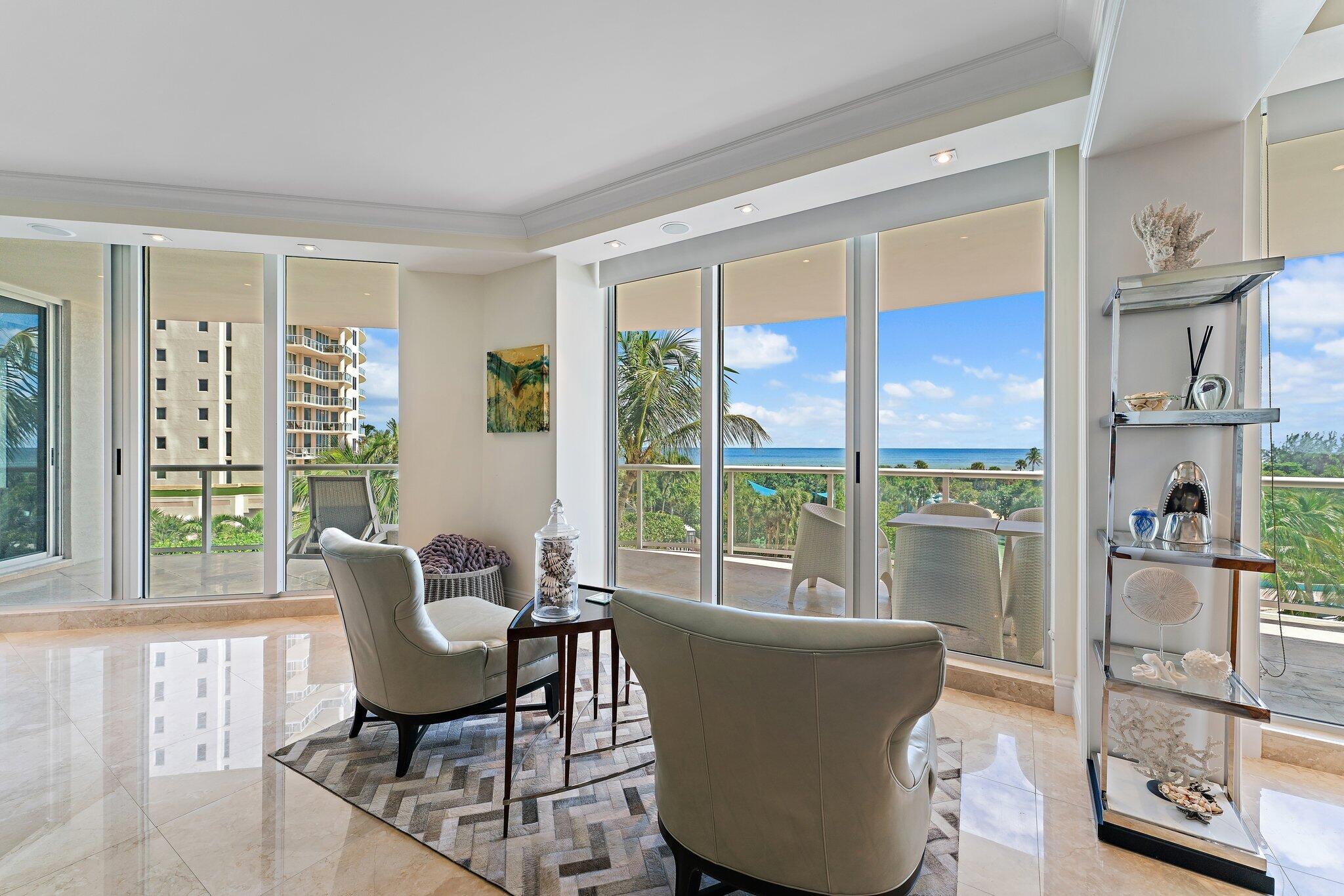 2700 North Ocean Drive, Unit 304B Singer Island, FL 33404 - Photo 65 of 91 a living room with furniture and a floor to ceiling window