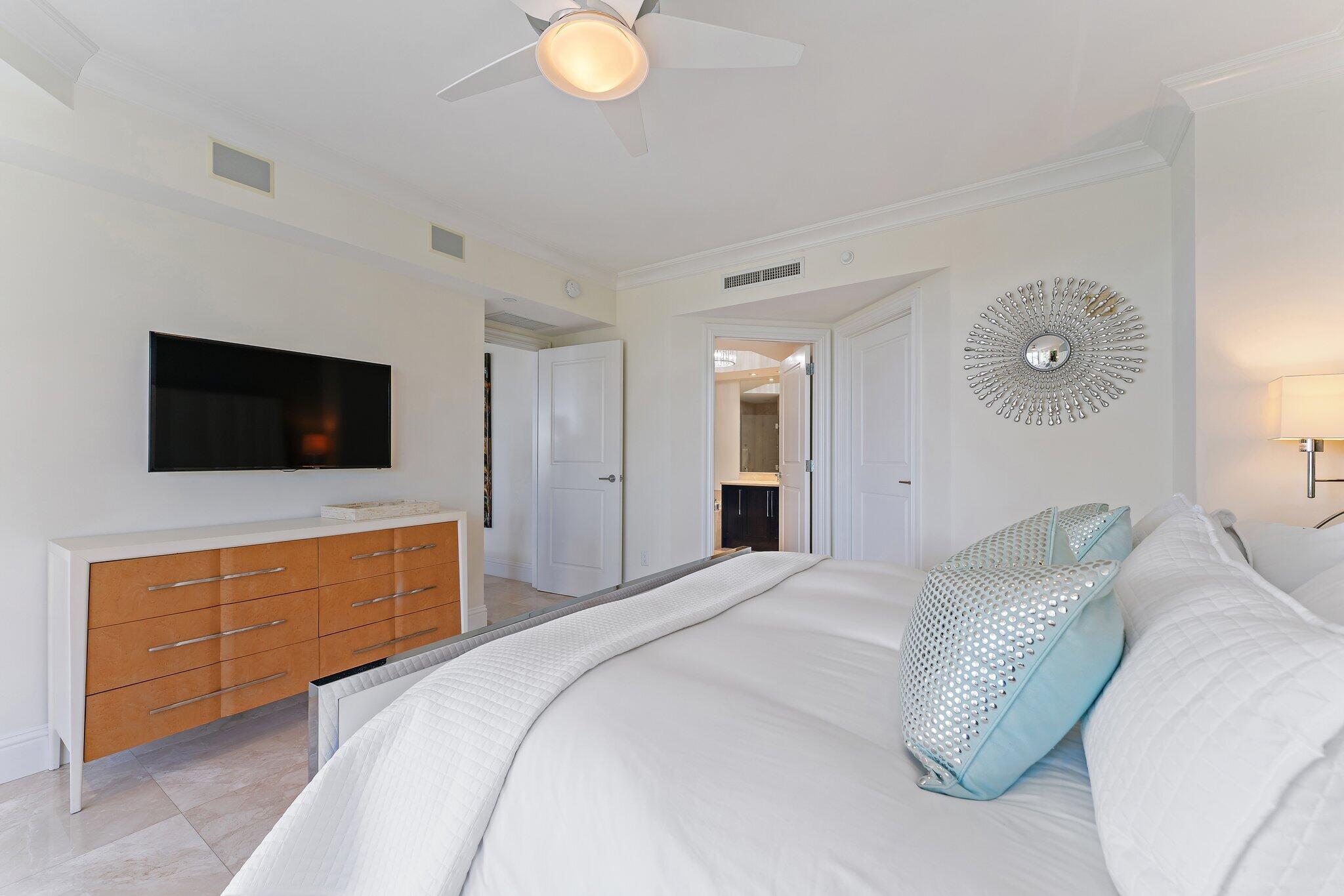 2700 North Ocean Drive, Unit 304B Singer Island, FL 33404 - Photo 77 of 91 a bedroom with a bed and a flat screen tv
