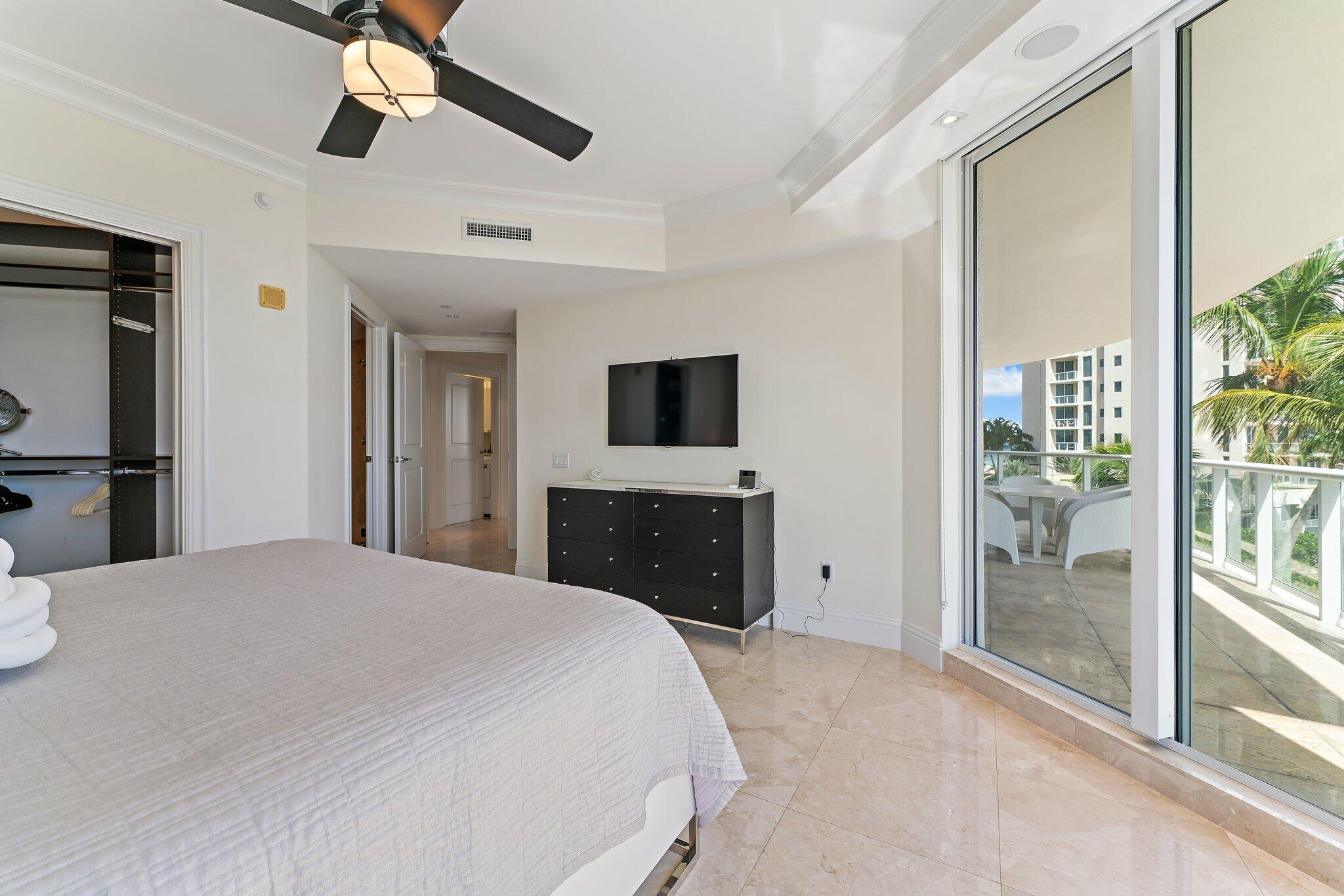 2700 North Ocean Drive, Unit 304B Singer Island, FL 33404 - Photo 88 of 91 a bedroom with a bed and a flat screen tv