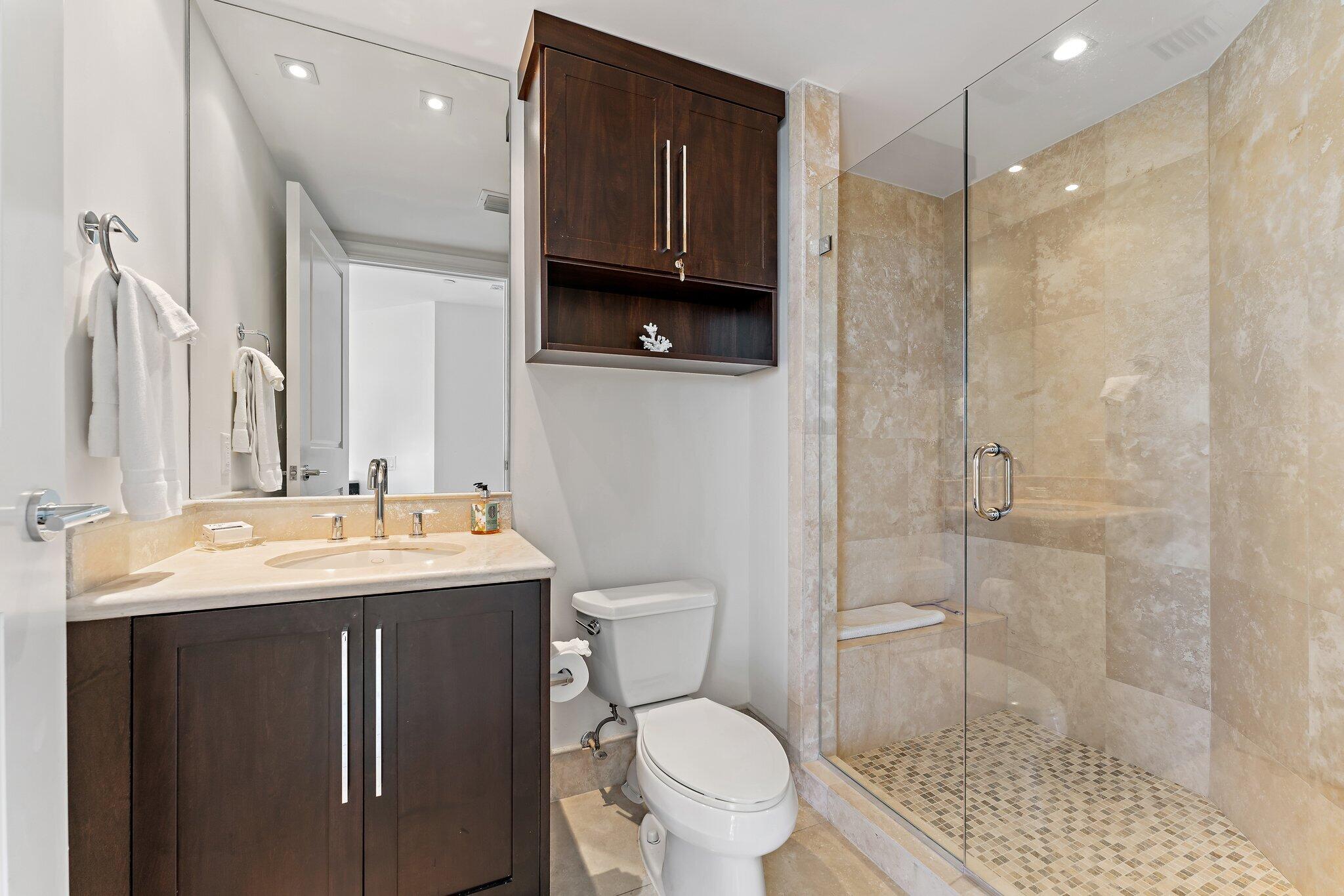 2700 North Ocean Drive, Unit 304B Singer Island, FL 33404 - Photo 91 of 91 a bathroom with a granite countertop sink a toilet a mirror and shower