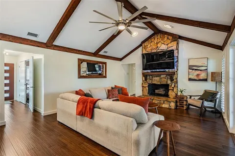 a living room with fireplace furniture and a wooden floor