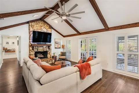 a living room with fireplace furniture and a flat screen tv