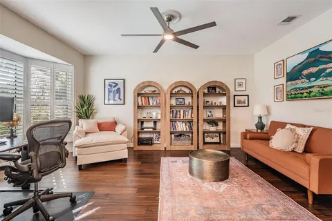 a living room with fireplace furniture and windows
