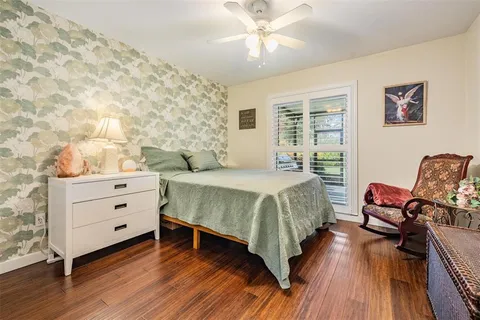 a spacious bedroom with a bed and a dresser