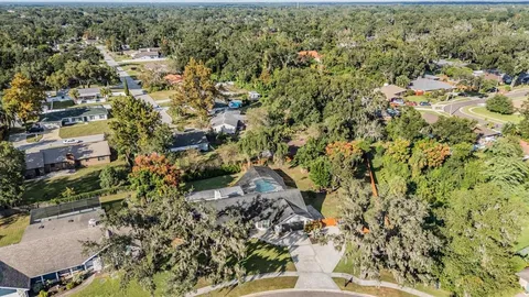 a front view of a house with swimming pool having outdoor seating