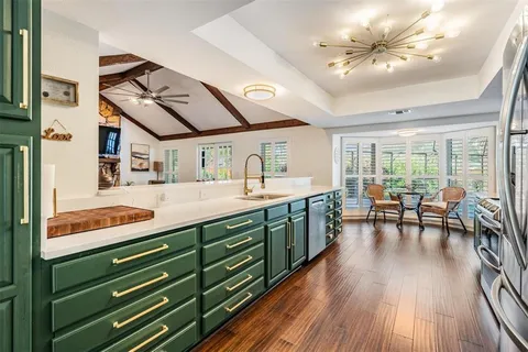 a spacious bathroom with a granite countertop sink and a large mirror