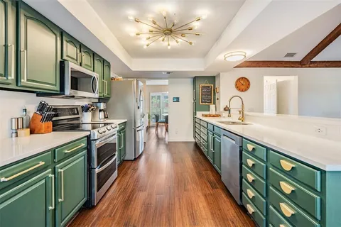 a kitchen with stainless steel appliances sink and cabinets