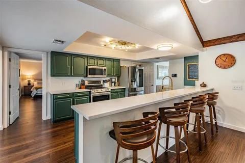 a large kitchen with a table and chairs in it