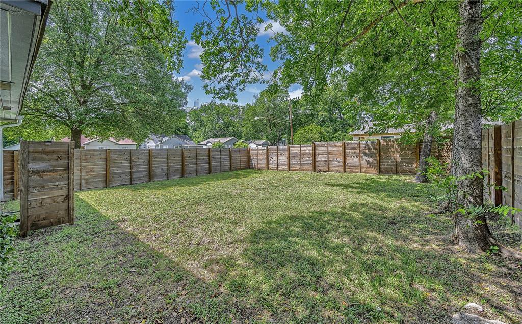 2523 McKenzie Avenue Waco, TX 76708 - Photo 37 of 40 Expansive backyard featuring a full perimeter privacy fence, natural grass lawn, and mature trees providing natural shade
