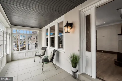 a living room with furniture and large windows
