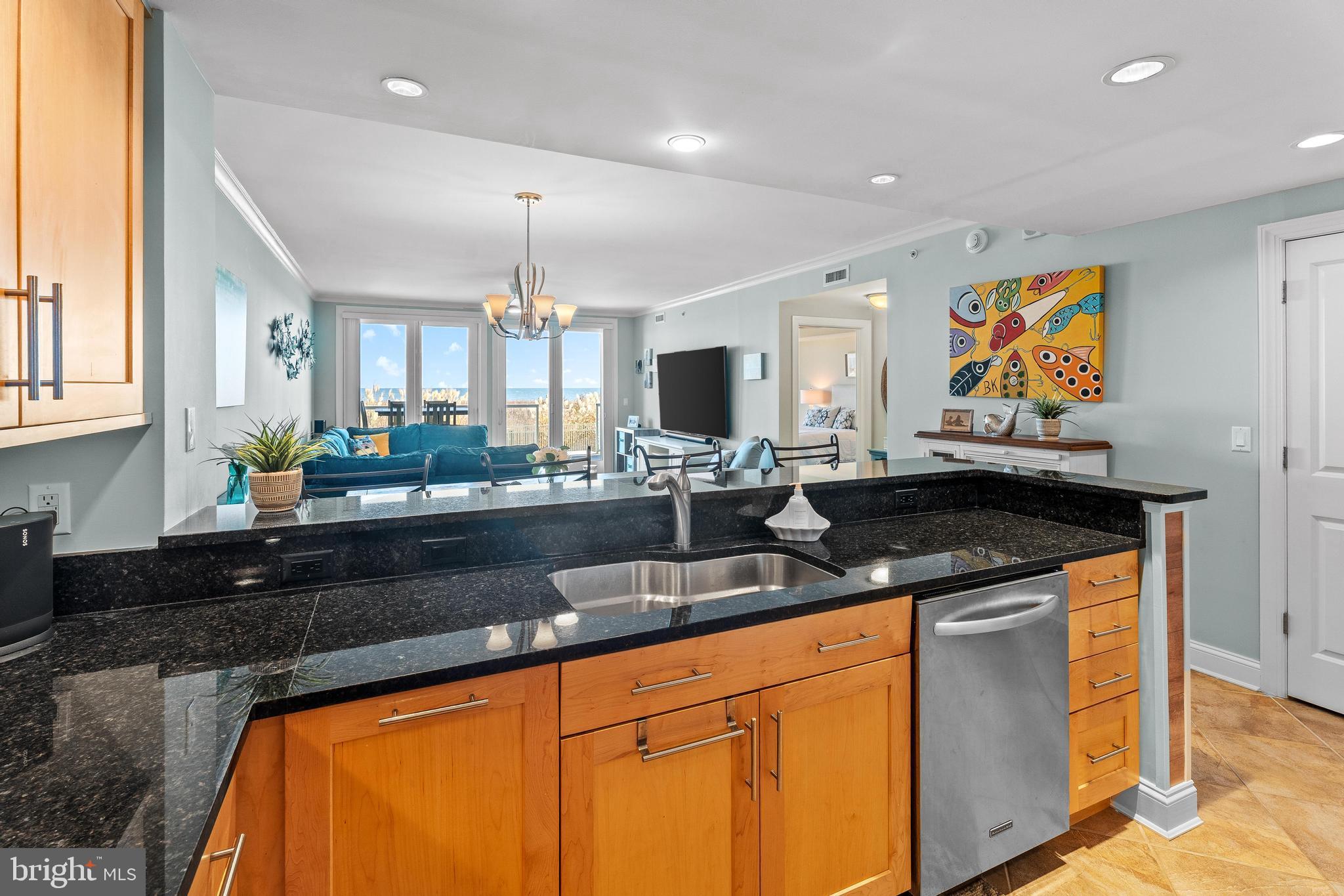 6 60th Street, Unit 102 Ocean City, MD 21842 - Photo 15 of 58 a kitchen with stainless steel appliances granite countertop a sink and cabinets