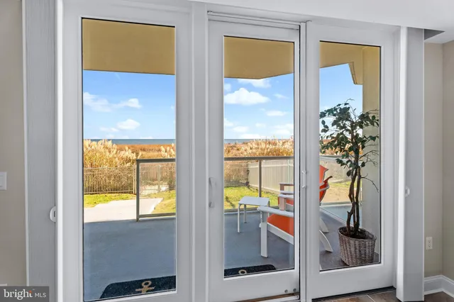 a spacious bedroom with a bed and a flat tv screen on dresser