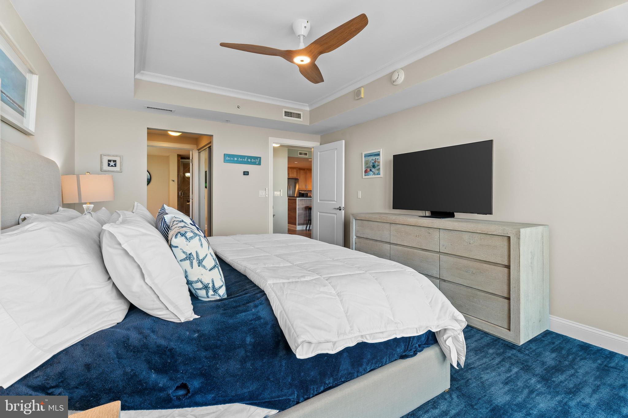 6 60th Street, Unit 102 Ocean City, MD 21842 - Photo 20 of 58 a bedroom with a bed and a flat screen tv