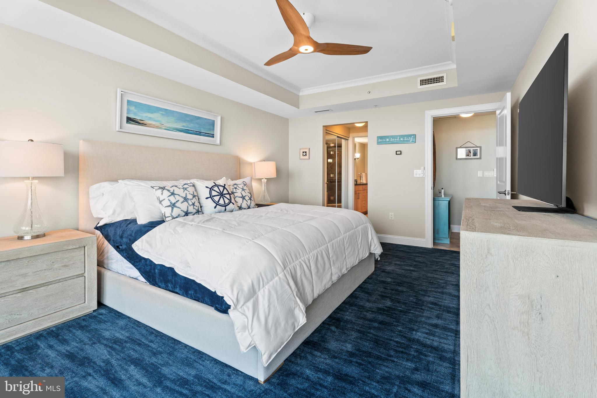 6 60th Street, Unit 102 Ocean City, MD 21842 - Photo 22 of 58 a bedroom with a bed and a flat screen tv