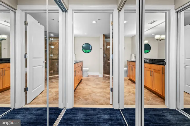 a bathroom with a granite countertop sink mirror and shower