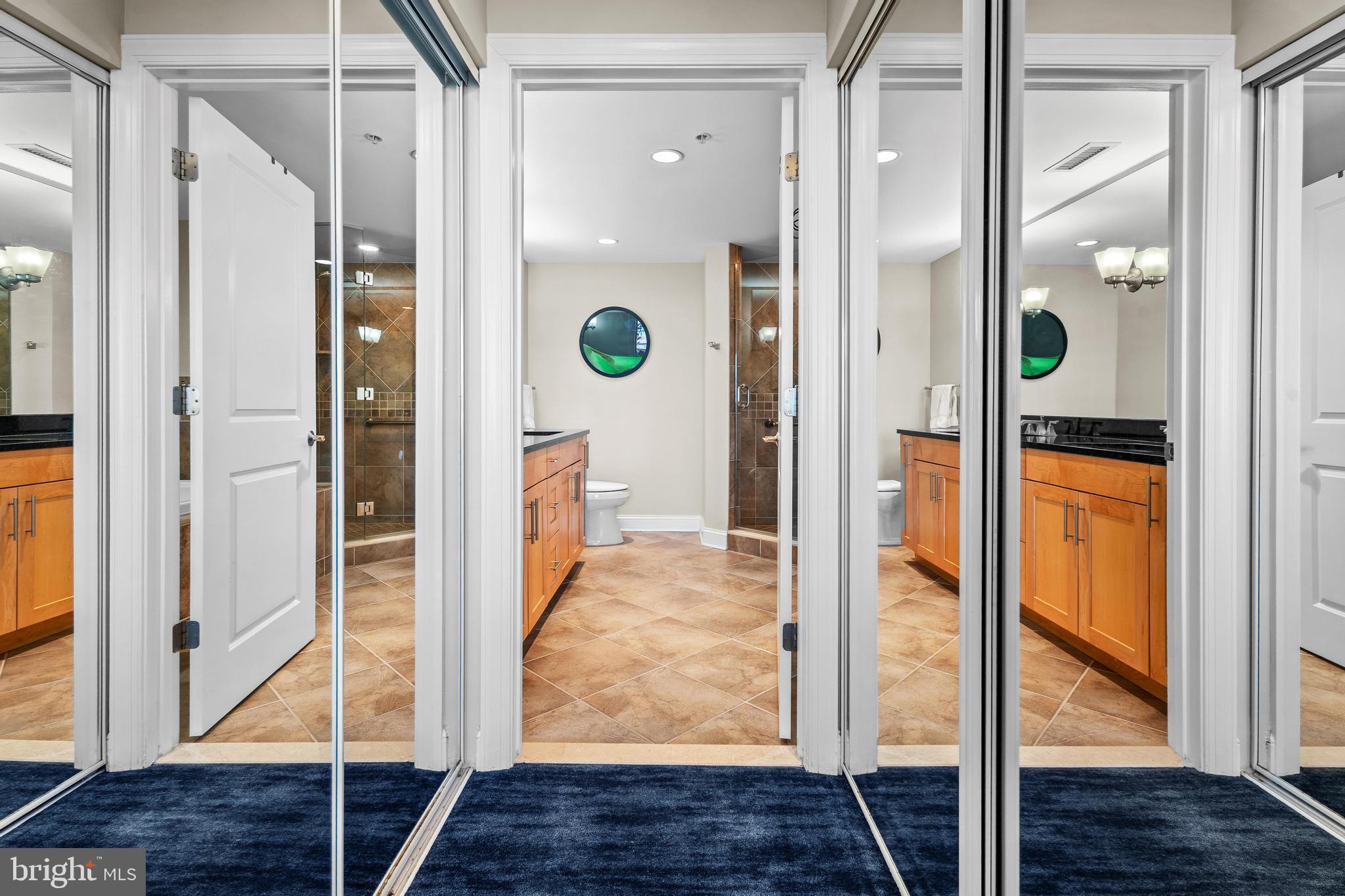 6 60th Street, Unit 102 Ocean City, MD 21842 - Photo 23 of 58 a bathroom with a glass shower door and a mirror