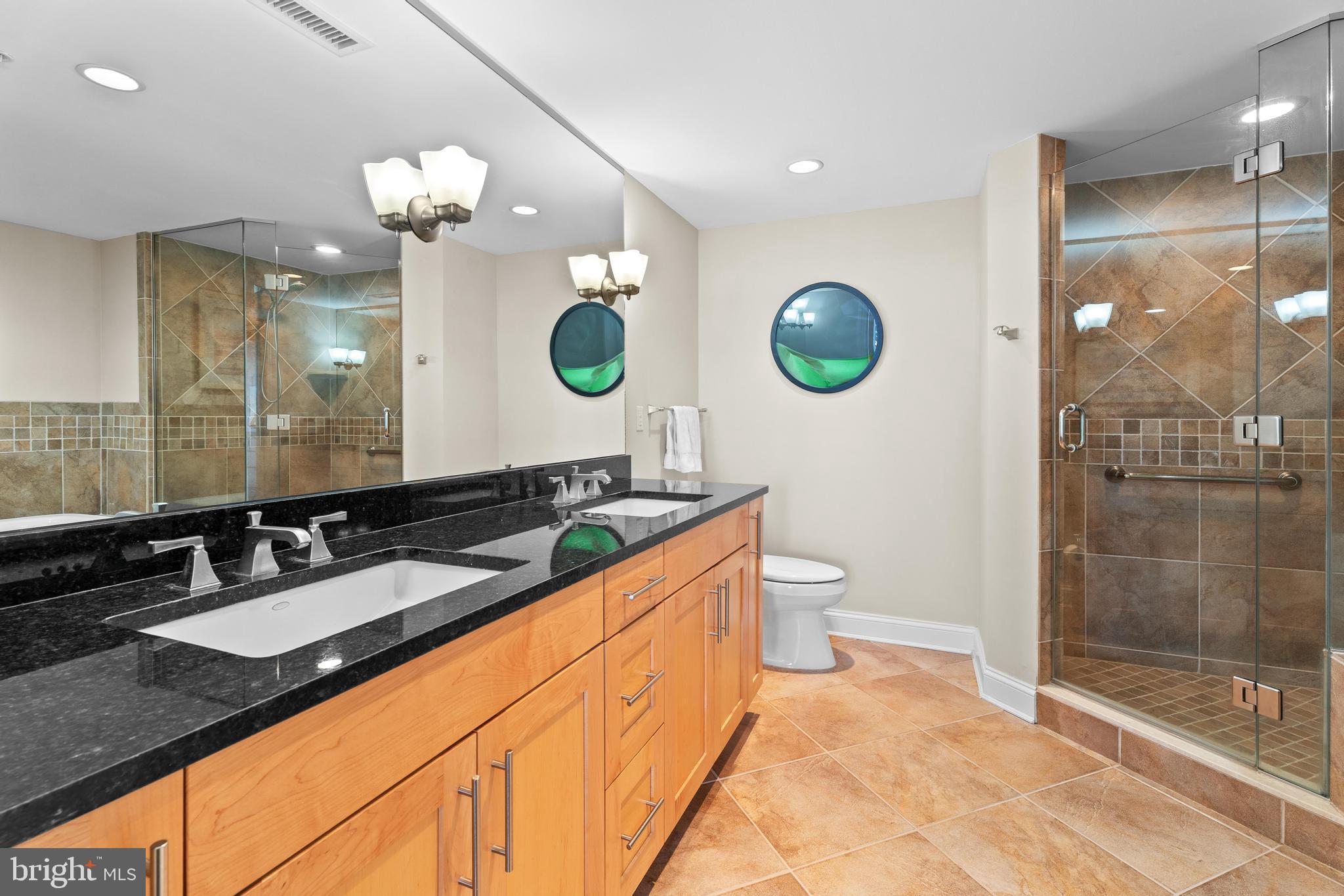 6 60th Street, Unit 102 Ocean City, MD 21842 - Photo 24 of 58 a bathroom with a granite countertop sink mirror and shower