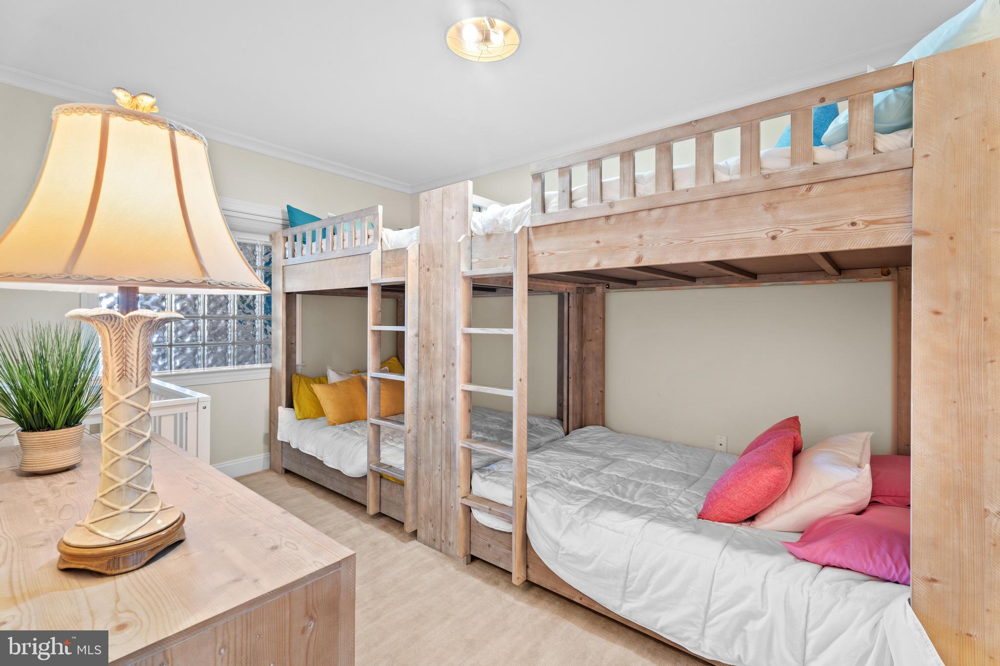 6 60th Street, Unit 102 Ocean City, MD 21842 - Photo 29 of 58 a bedroom with a bed and a window