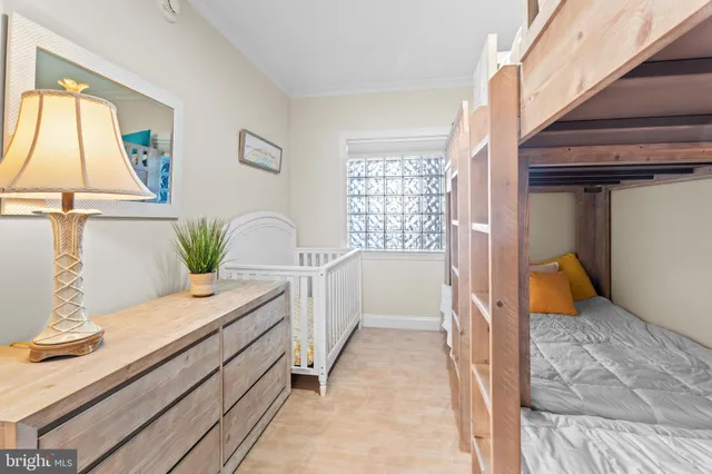 a bedroom with a large bed and a potted plant