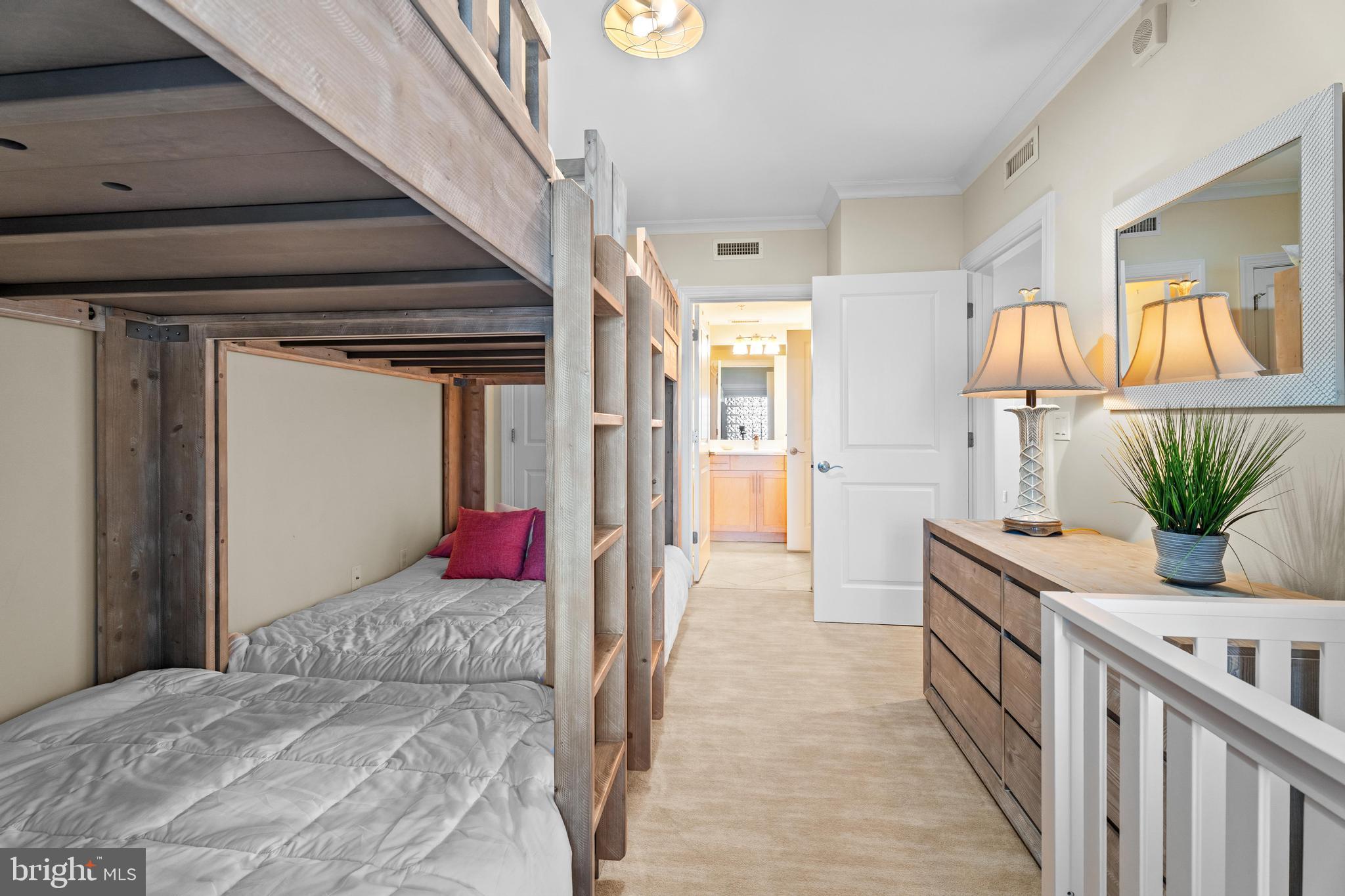 6 60th Street, Unit 102 Ocean City, MD 21842 - Photo 31 of 58 a bedroom with furniture and a bed