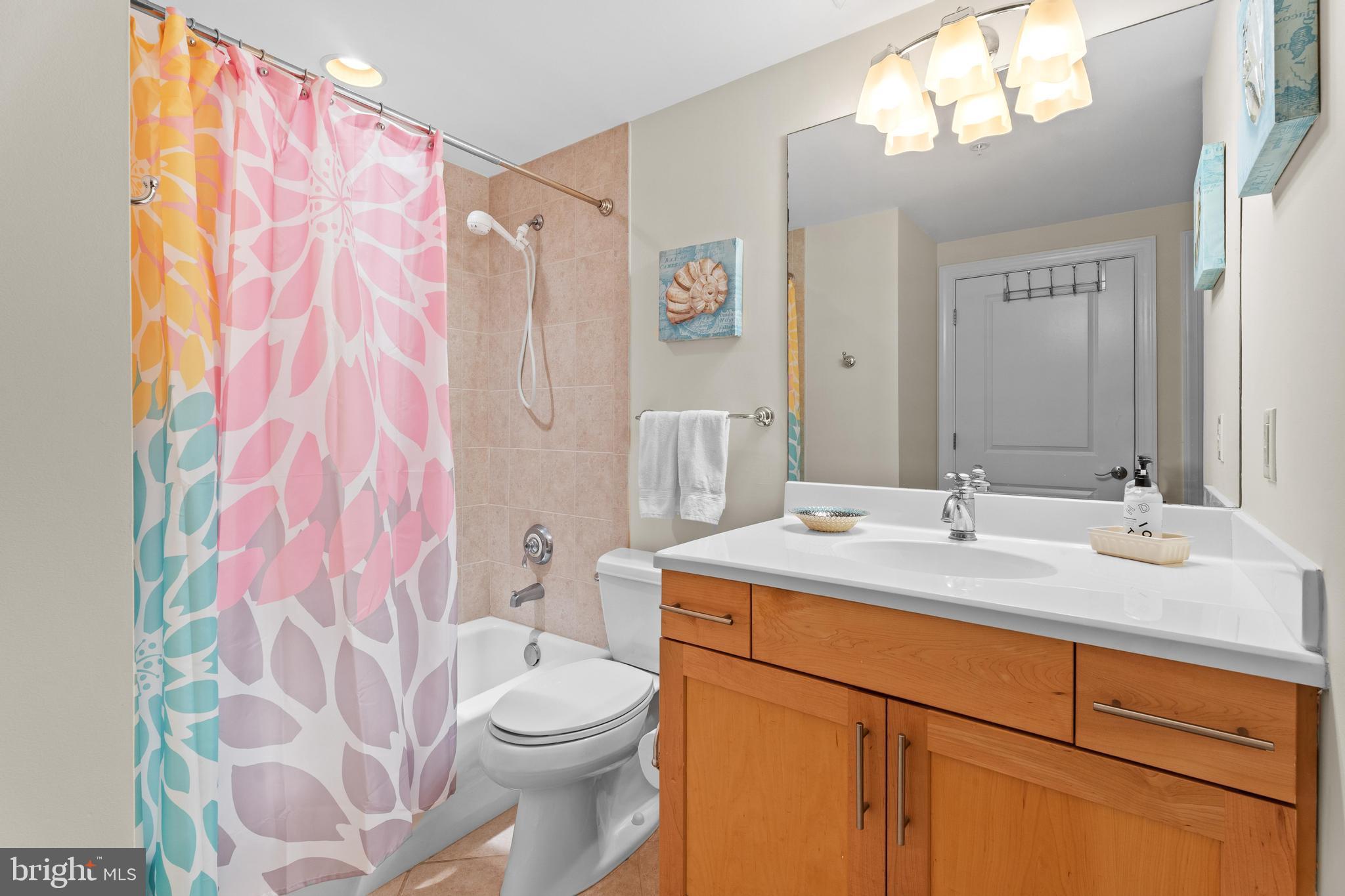 6 60th Street, Unit 102 Ocean City, MD 21842 - Photo 33 of 58 a bathroom with a sink vanity mirror and toilet