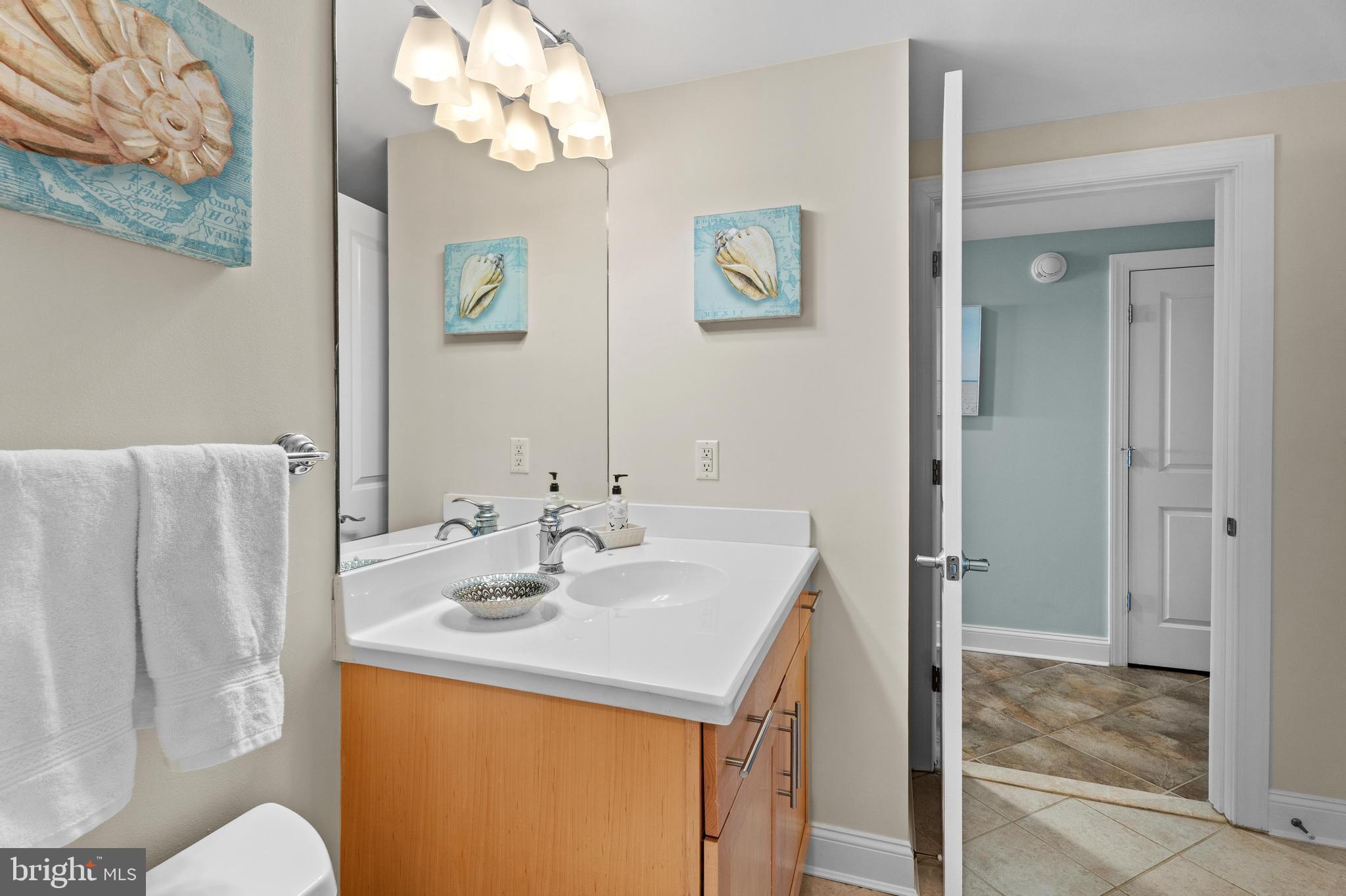 6 60th Street, Unit 102 Ocean City, MD 21842 - Photo 34 of 58 a bathroom with a sink vanity and a mirror