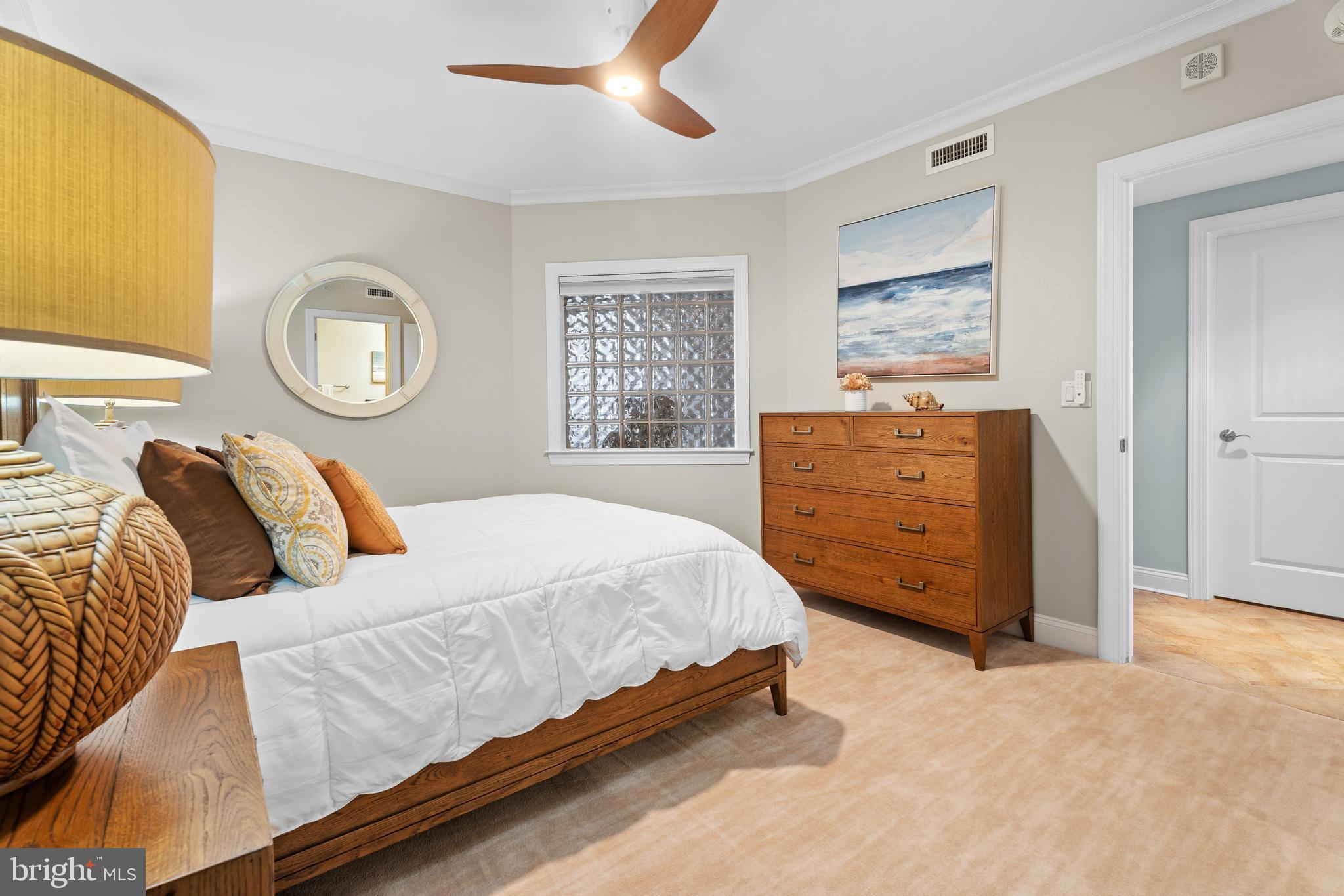 6 60th Street, Unit 102 Ocean City, MD 21842 - Photo 38 of 58 a bedroom with a bed and a dresser