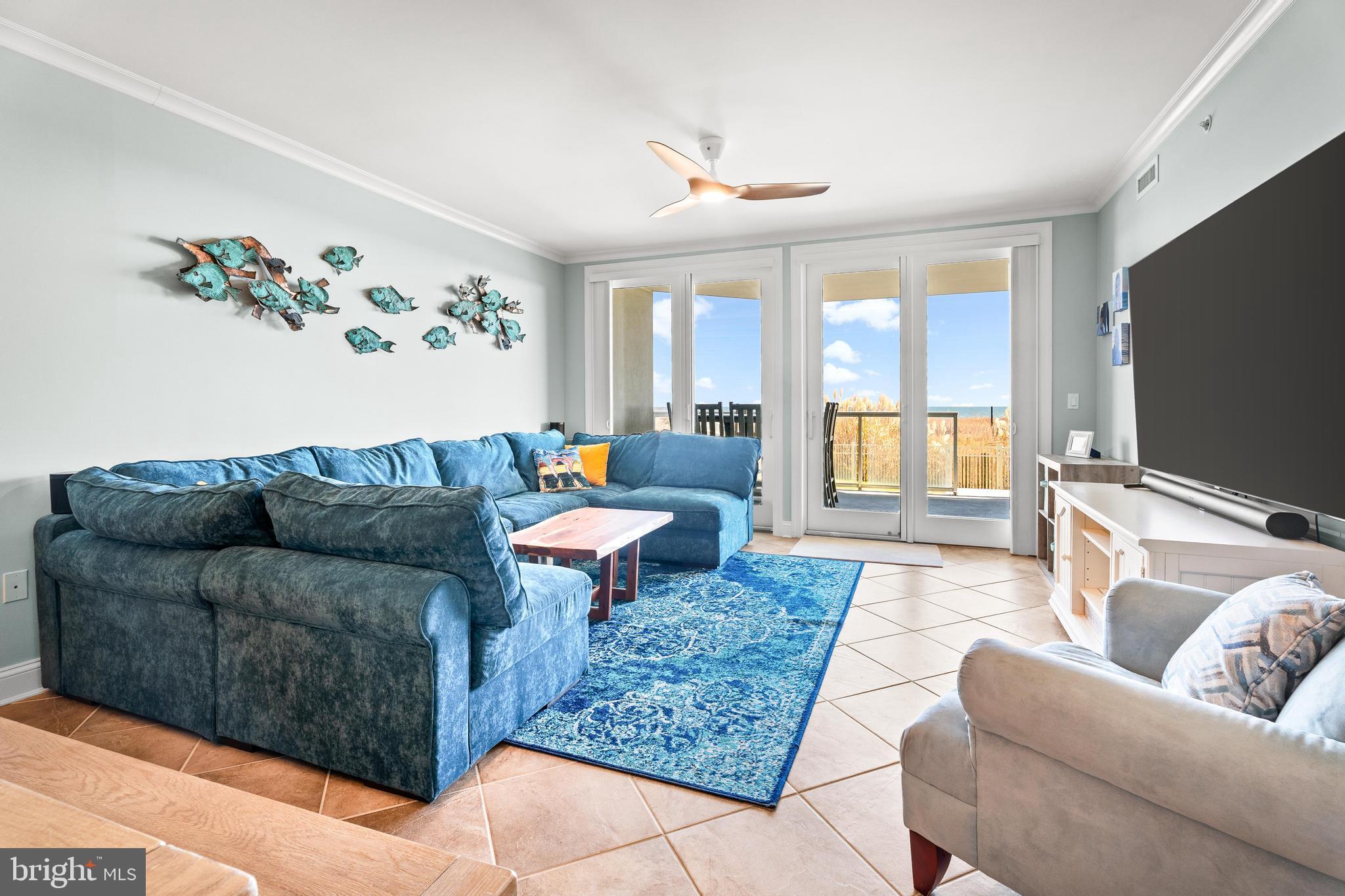 6 60th Street, Unit 102 Ocean City, MD 21842 - Photo 4 of 58 a living room with furniture and a flat screen tv