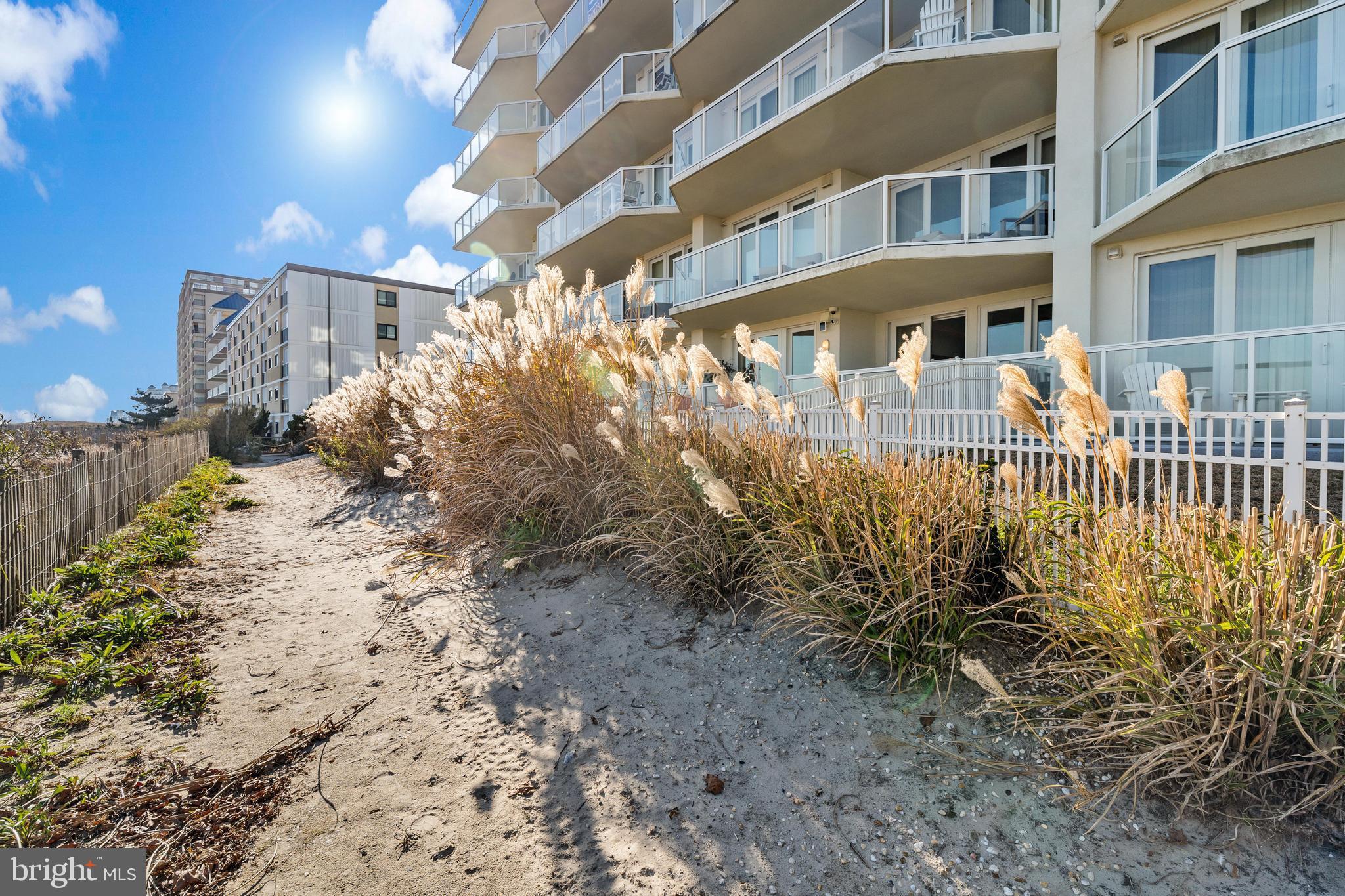 6 60th Street, Unit 102 Ocean City, MD 21842 - Photo 54 of 58 a view of a house with a yard and pathway