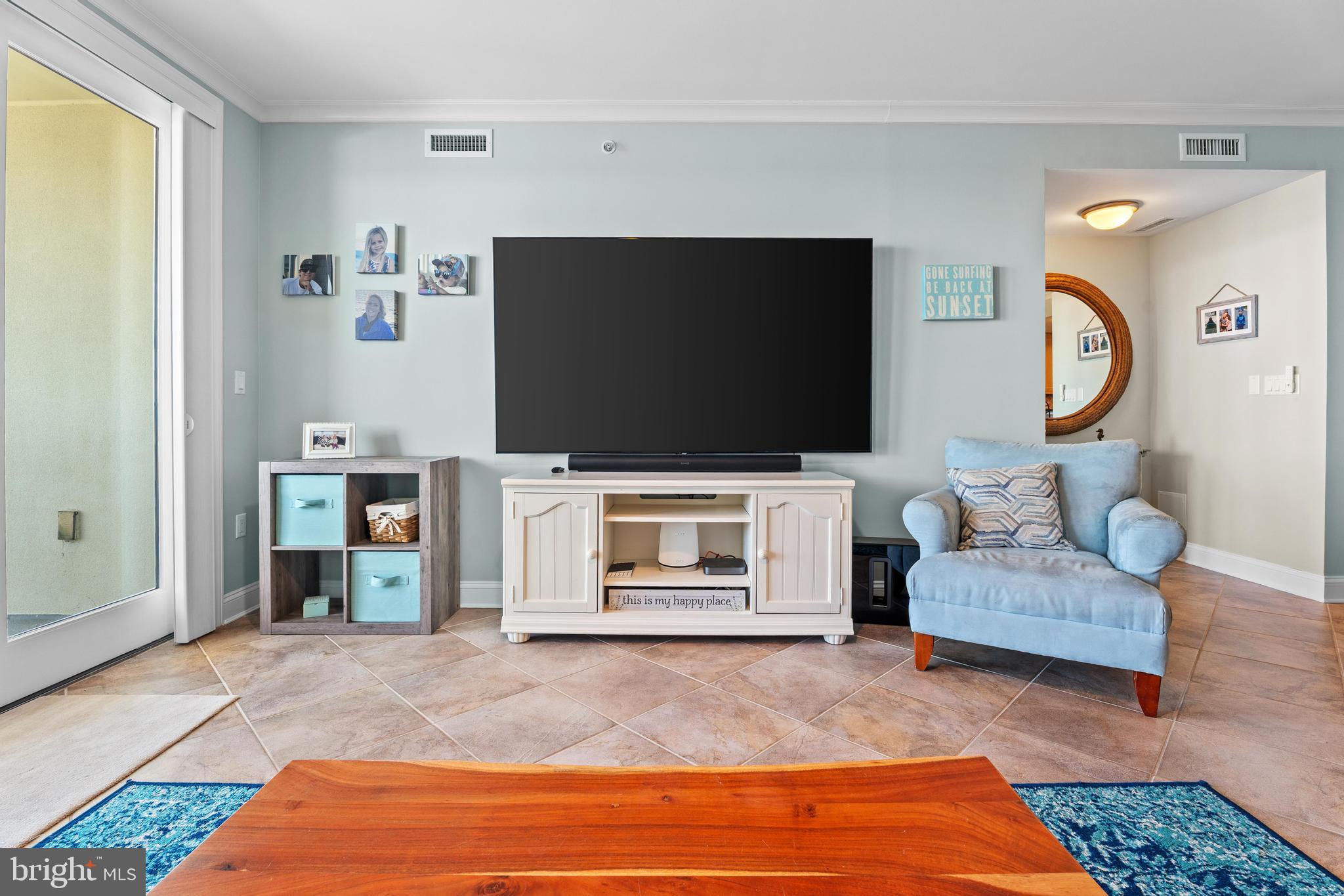 6 60th Street, Unit 102 Ocean City, MD 21842 - Photo 6 of 58 a living room with furniture and a flat screen tv