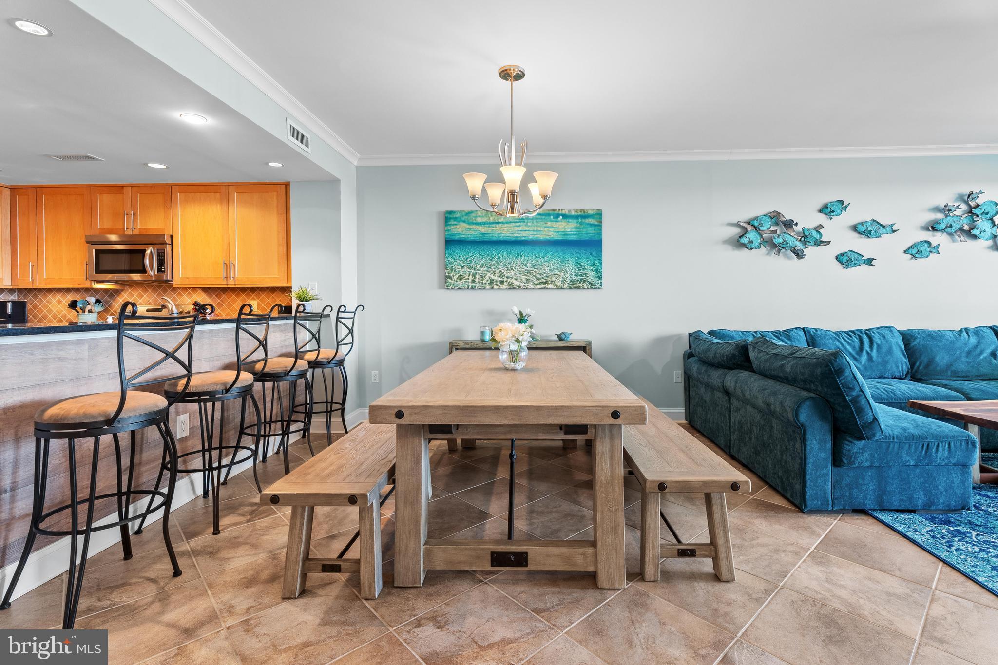 6 60th Street, Unit 102 Ocean City, MD 21842 - Photo 9 of 58 a living room with furniture a window and a chandelier