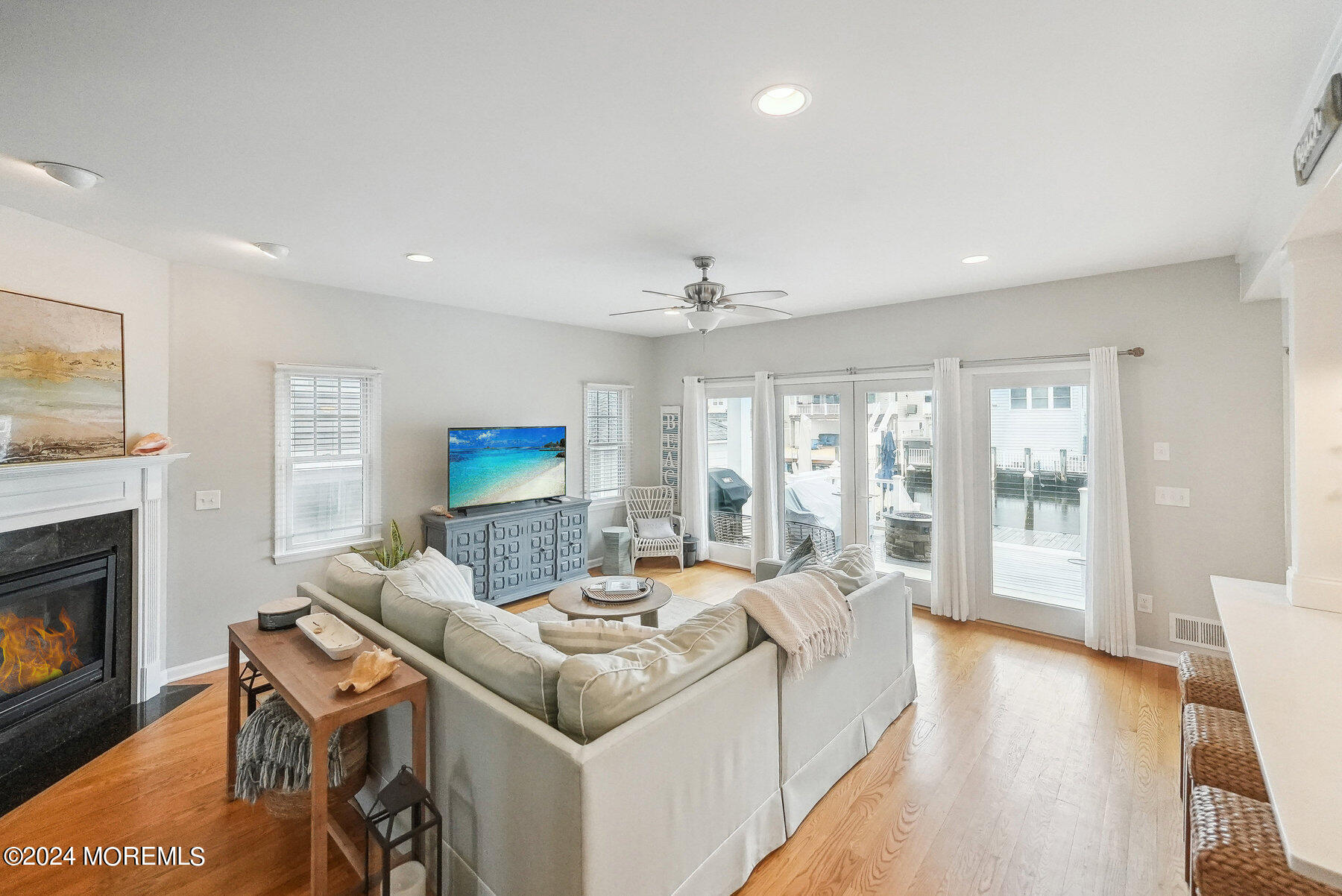 472 Brielle Road Manasquan, NJ 08736 - Photo 17 of 52 a living room with furniture a fireplace and a flat screen tv