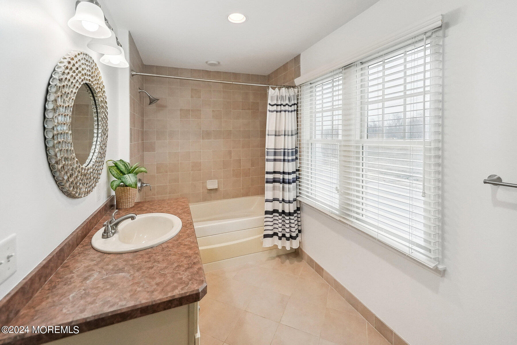 472 Brielle Road Manasquan, NJ 08736 - Photo 25 of 52 a bathroom with a granite countertop sink a mirror and a shower