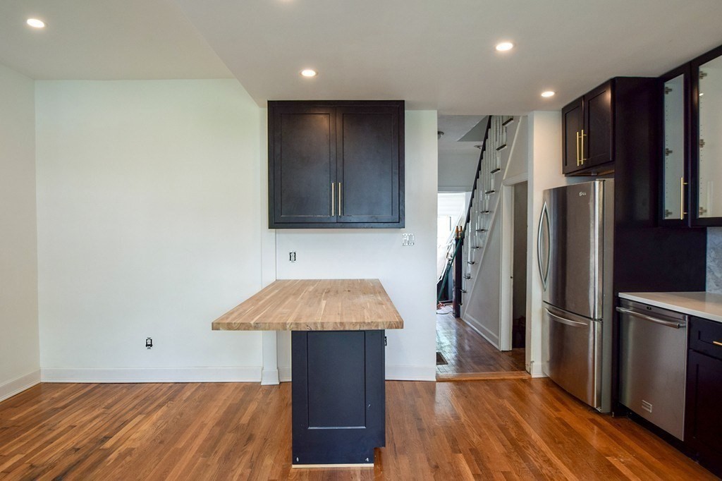 32 Cedar Street, Unit RIGHT Boston, MA 02126 - Photo 3 of 11 a kitchen with a refrigerator and a sink