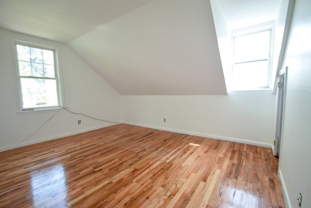 32 Cedar Street, Unit RIGHT Boston, MA 02126 - Photo 8 of 11 an empty room with wooden floor and windows