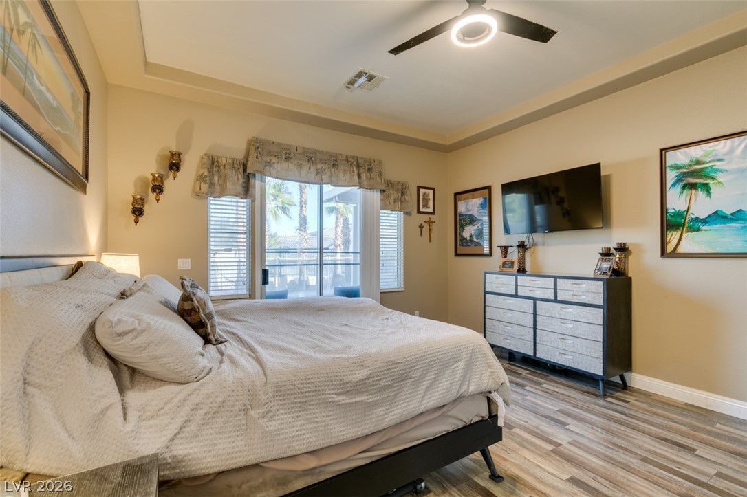7524 Midnight Rambler Street Las Vegas, NV 89149 - Photo 36 of 51 Palm trees visible through the window highlight this naturally illuminated bedroom with durable flooring.