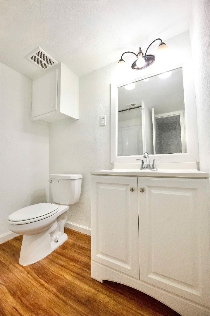 12048 Beechnut Street Houston, TX 77072 - Photo 10 of 13 a bathroom with a toilet sink and vanity