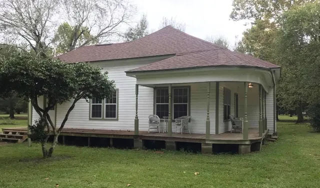 a front view of a house with a garden and porch