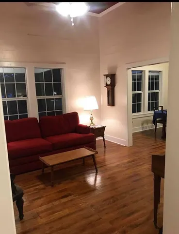 a living room with furniture window and wooden floor